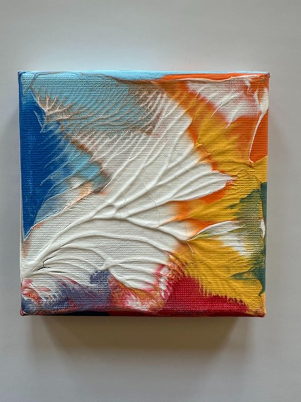 Abstract painting on a square canvas featuring textured, swirling patterns in blue, white, orange, yellow, red, and green. The composition highlights dynamic color transitions and raised, wave-like ridges creating a sense of movement and depth.